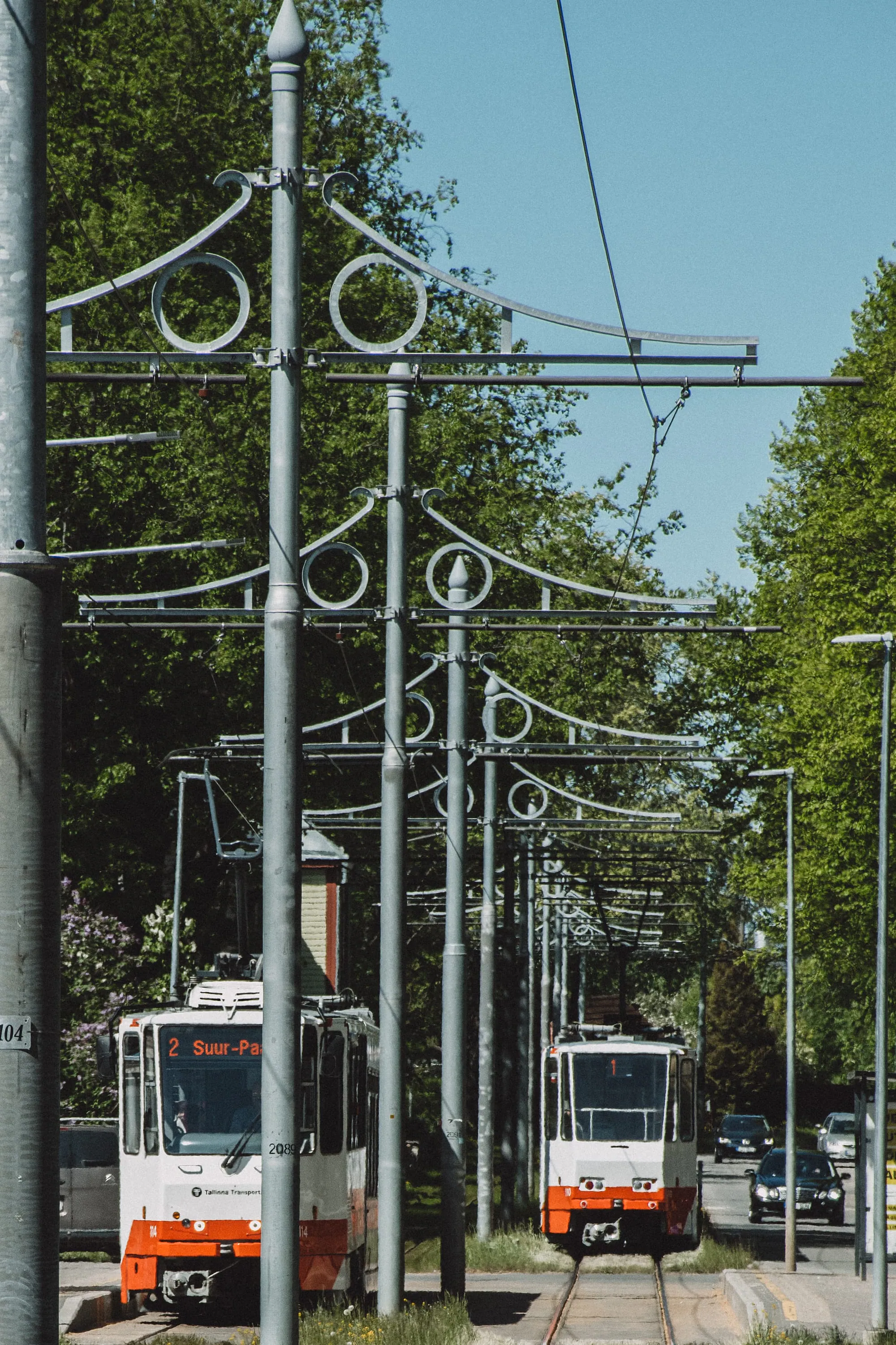Tallinn trams approaching beneath decorative overhead-line poles on Kopli Street