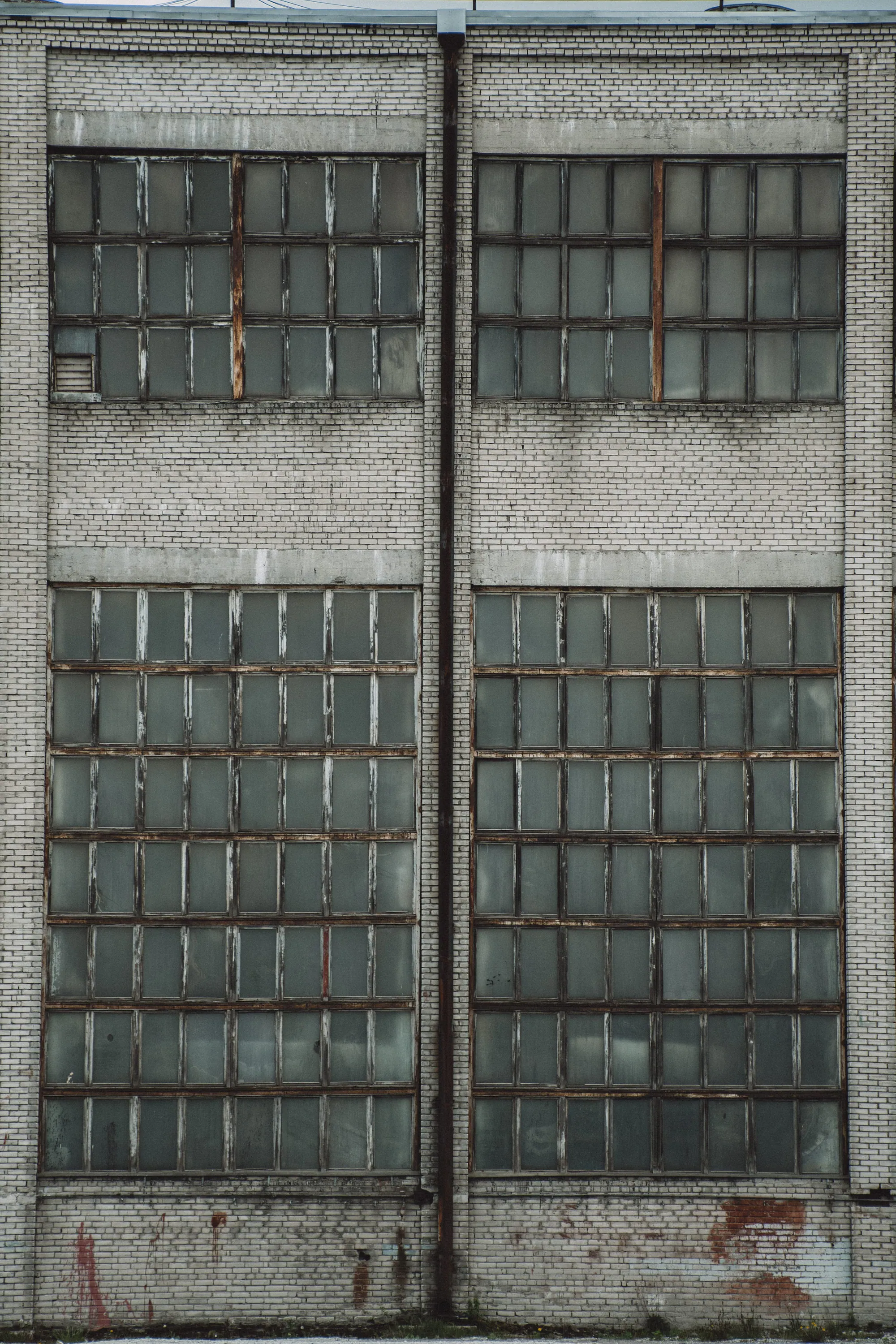 Large grid of ageing factory windows in the Kopli industrial district
