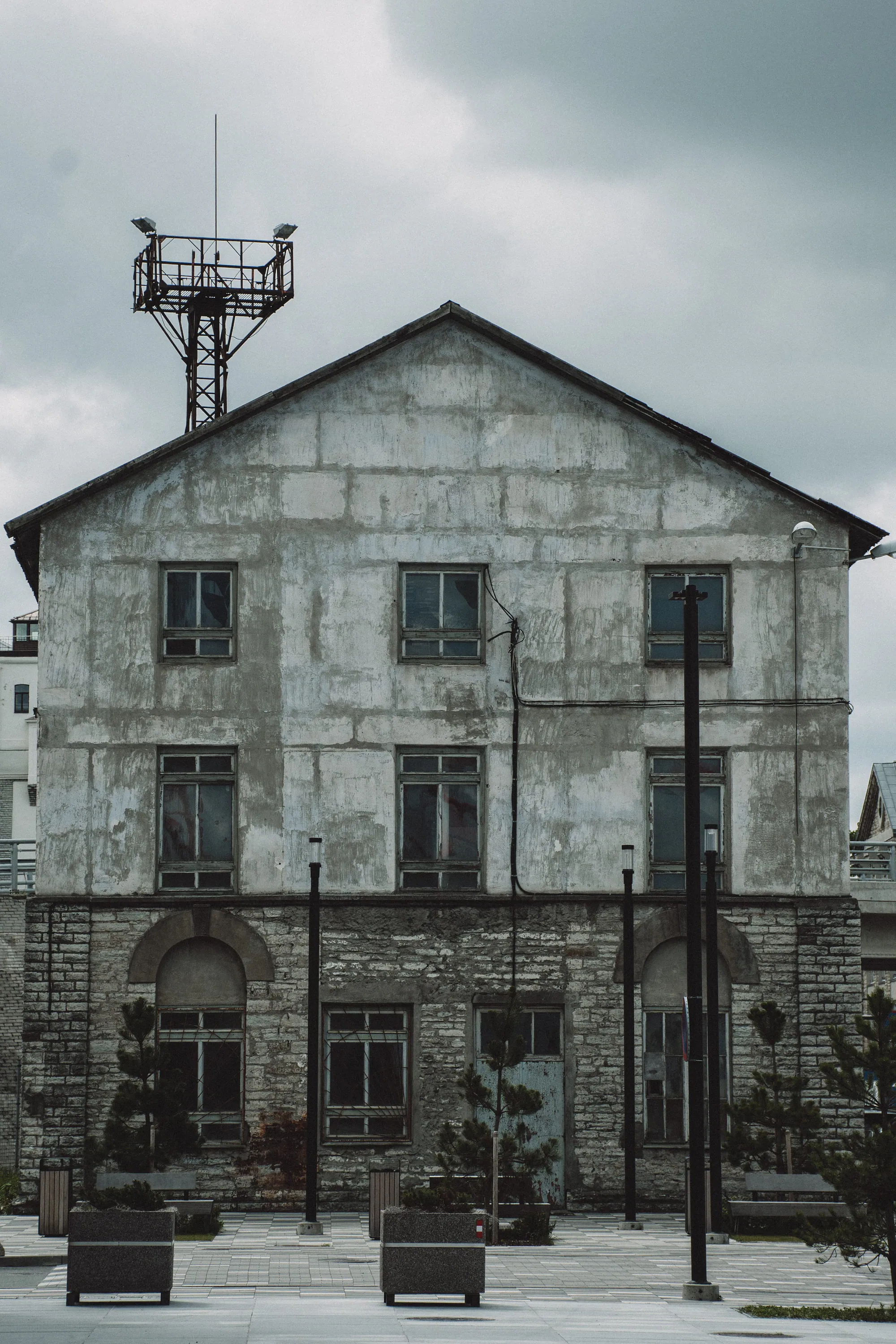 Symmetrical weathered industrial building under a grey sky in Kopli