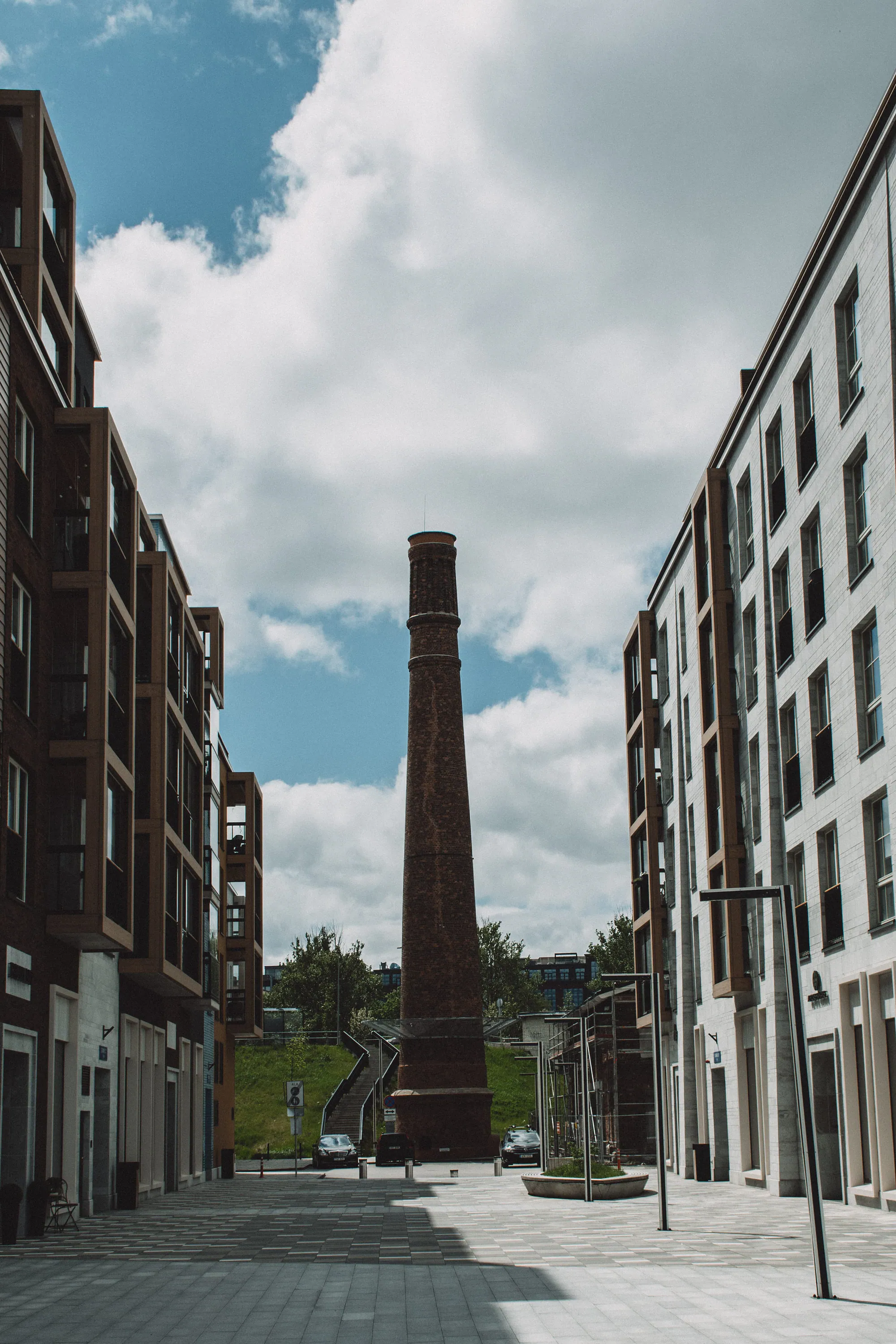Factory chimney framed between new apartment buildings in northern Tallinn