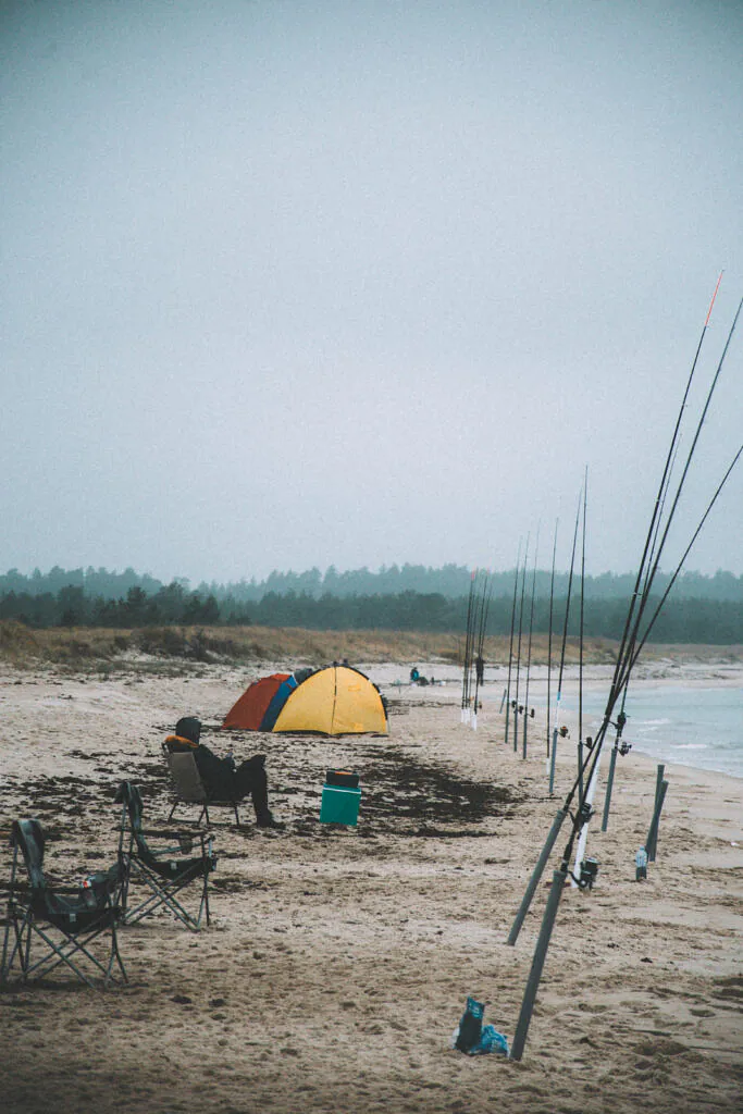 Fishing rods and an orange tent on misty Peraküla beach