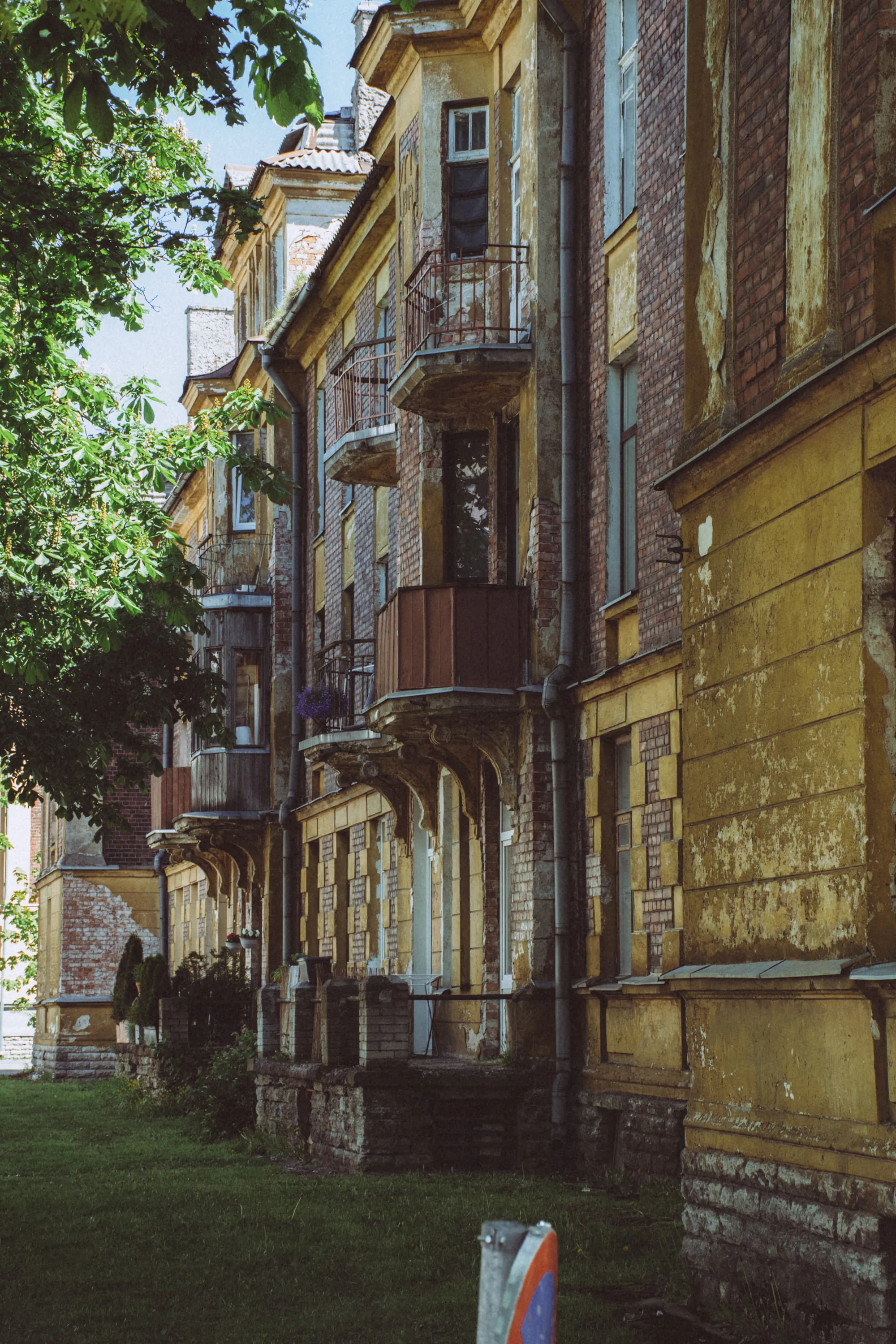 Narrow view between weathered residential façades in Kopli, Tallinn