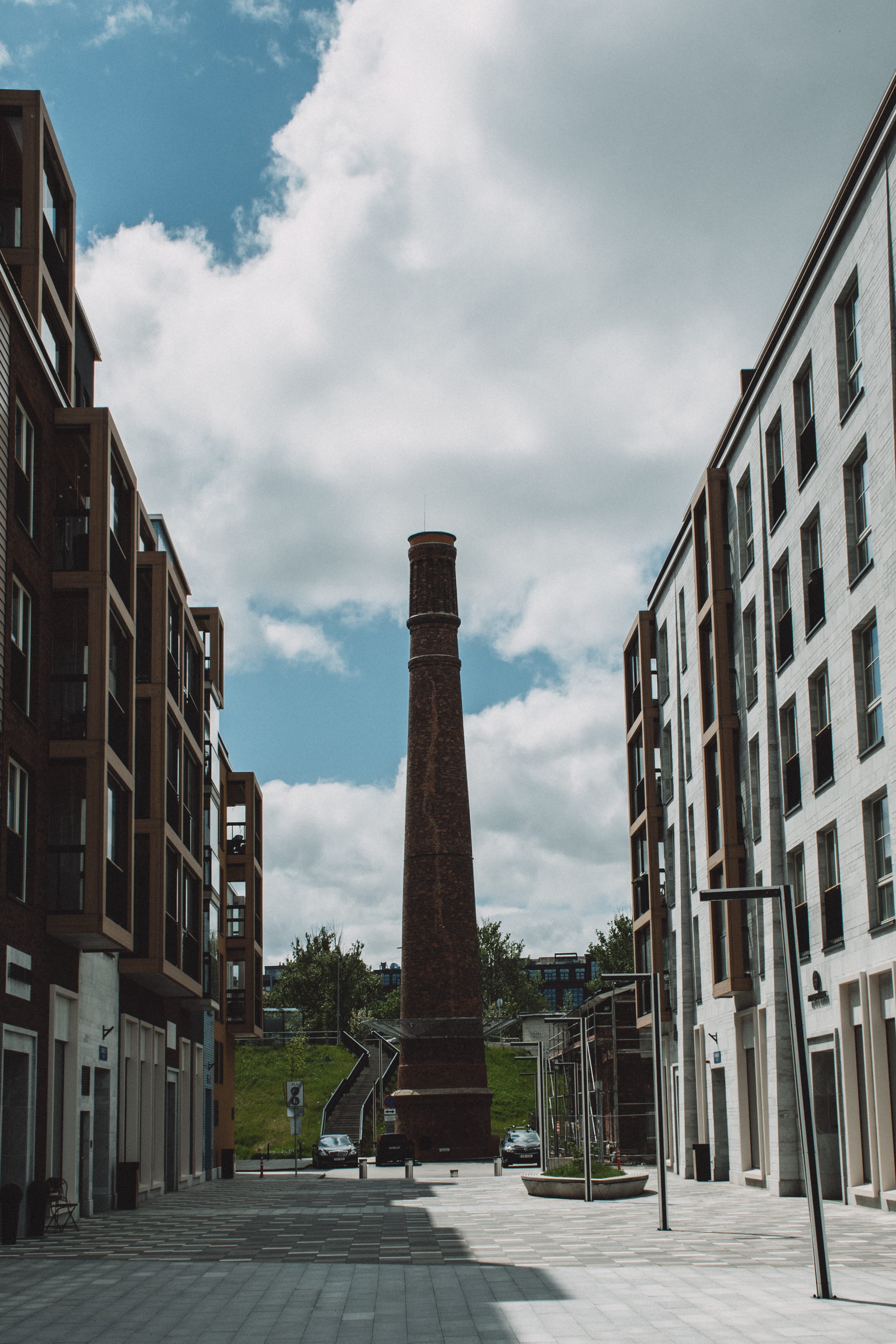 Factory chimney framed by old and new buildings in Kopli, Tallinn, Estonia.