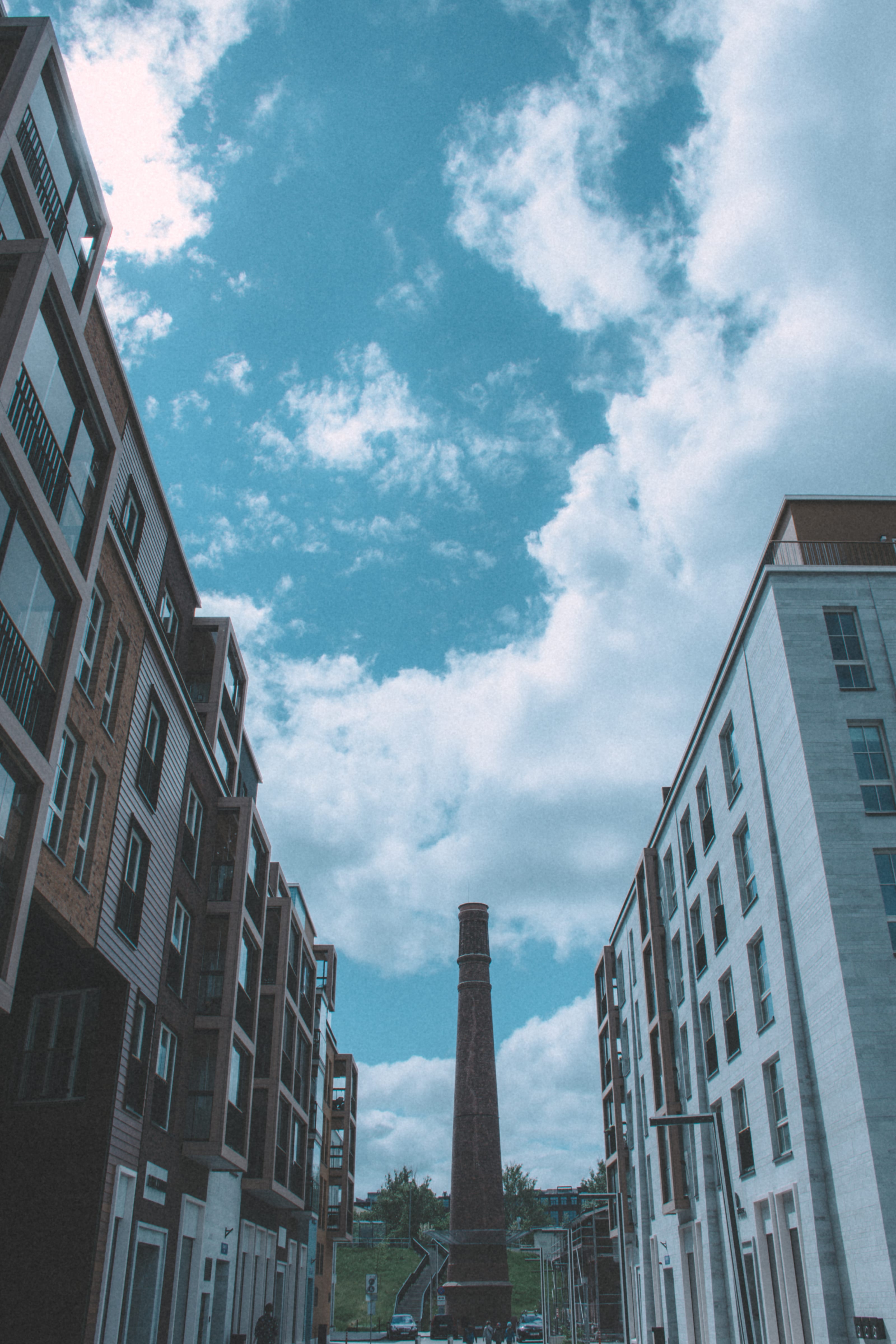 Industrial chimney rising between modern city blocks in Kopli, Tallinn, Estonia.