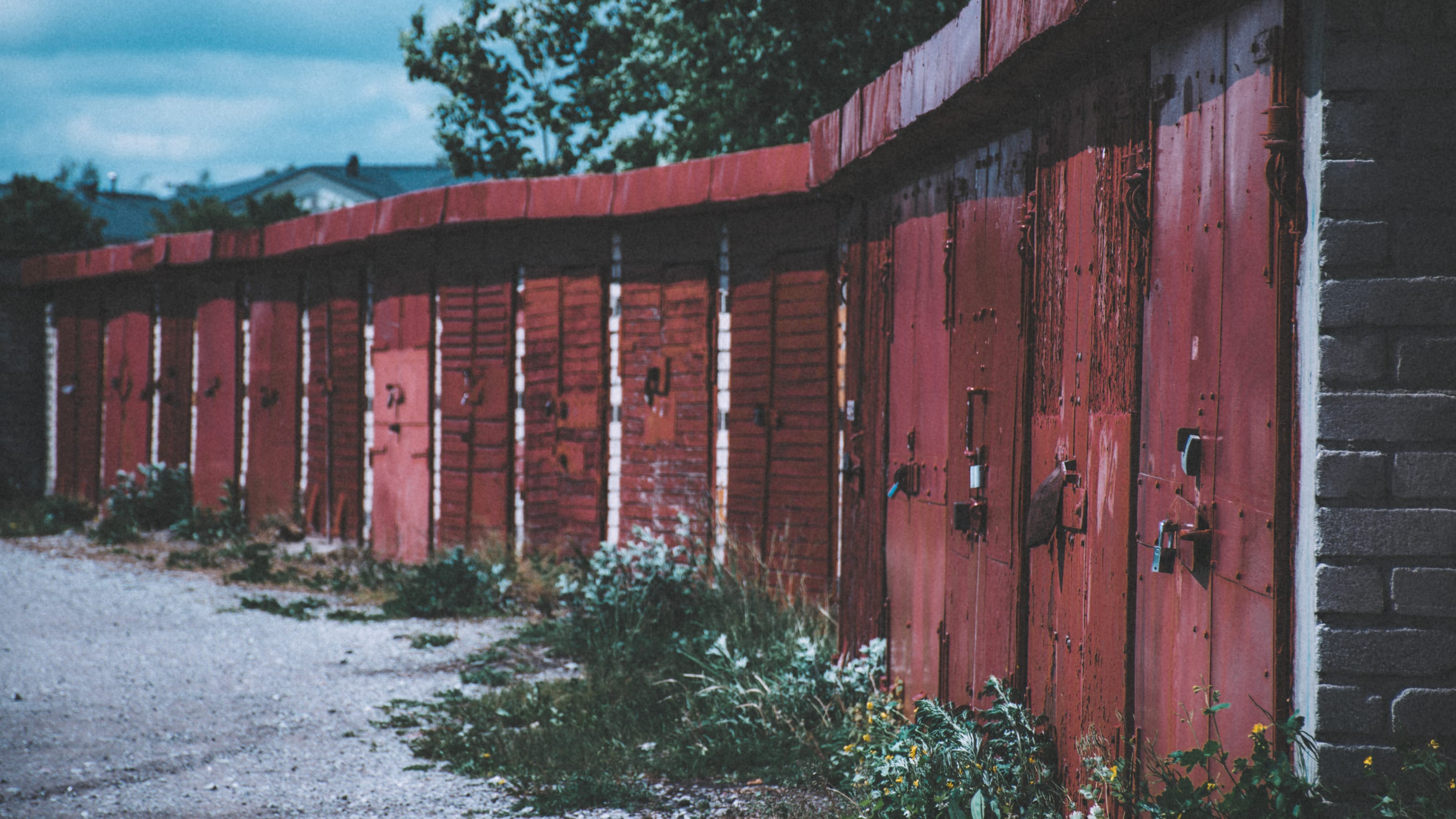 Long row of worn red garage doors in Kopli, Tallinn, Estonia.