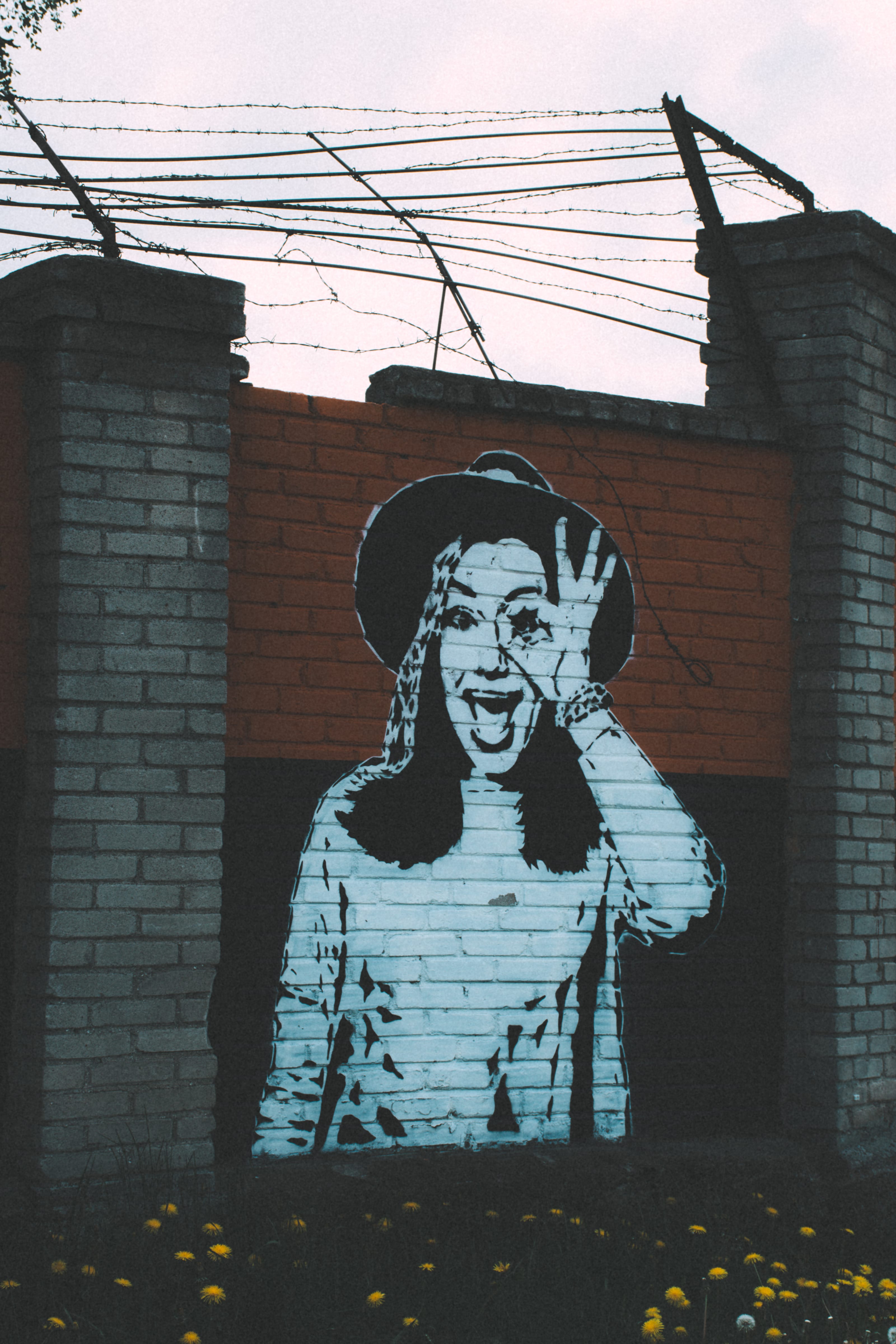 Black-and-white street art on a brick wall in Kopli, Tallinn, Estonia.