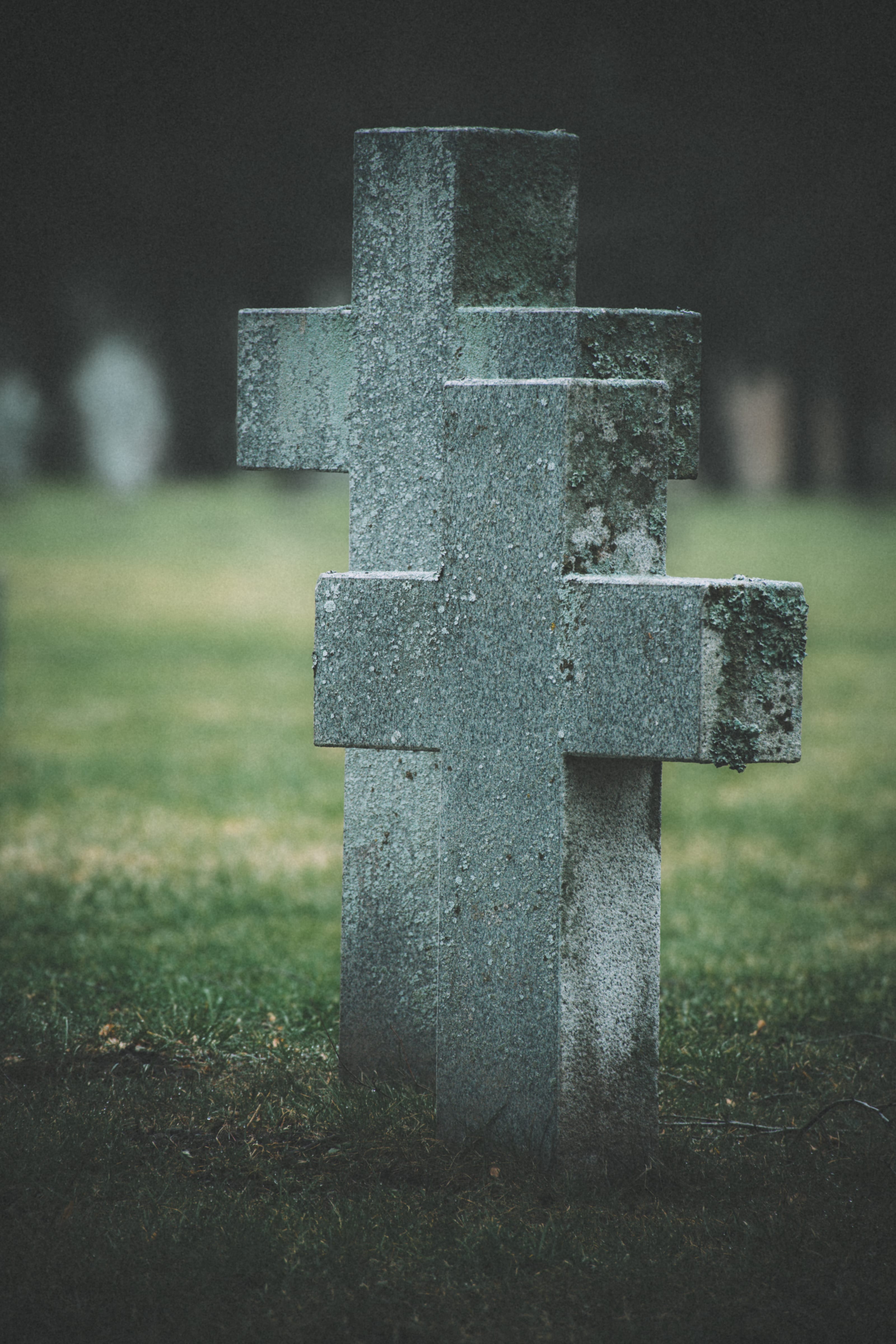 Stone cross standing in a quiet cemetery in Maarjamäe, Tallinn, Estonia.