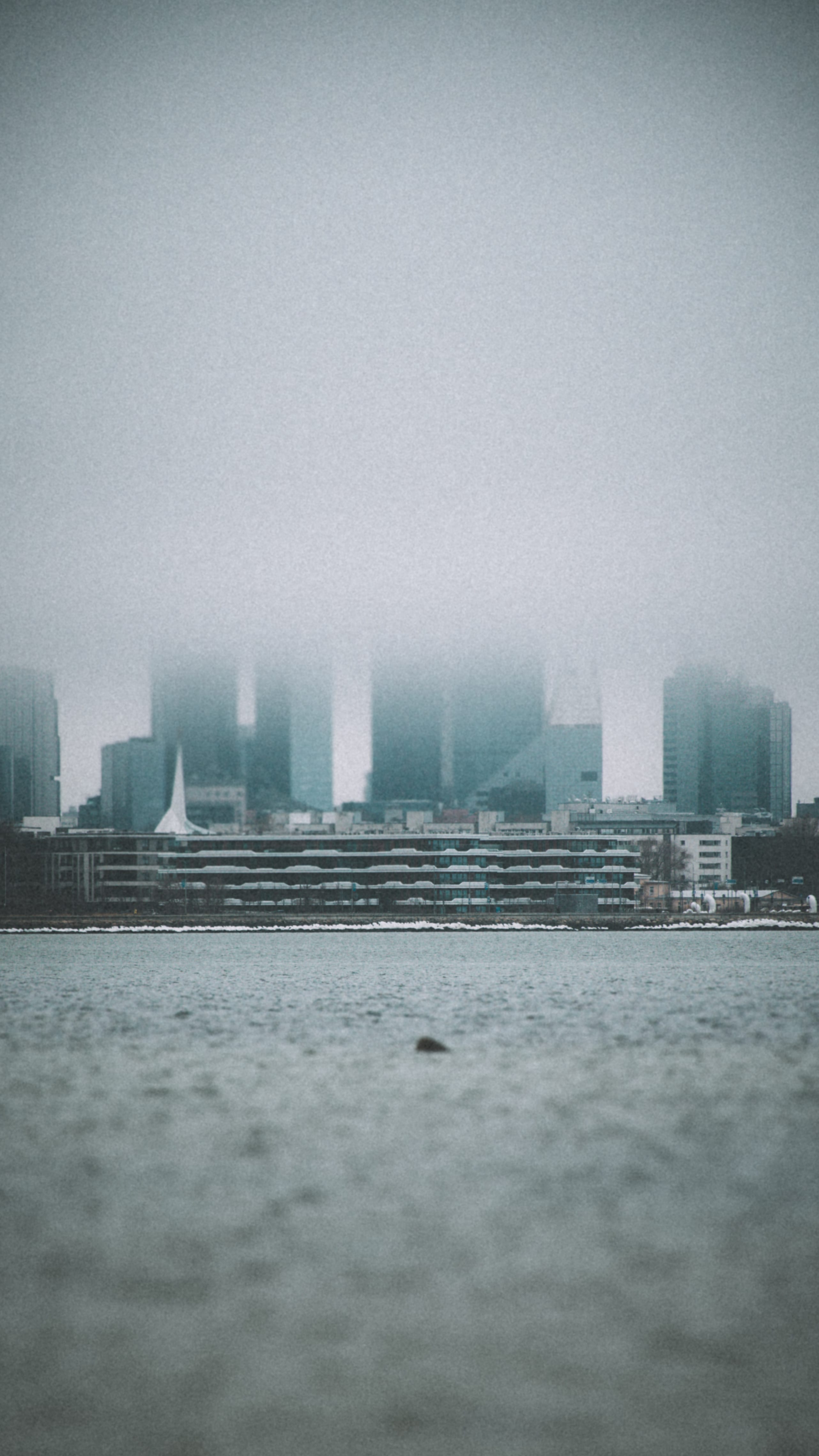 Tallinn waterfront buildings fading into sea fog in Maarjamäe, Tallinn, Estonia.