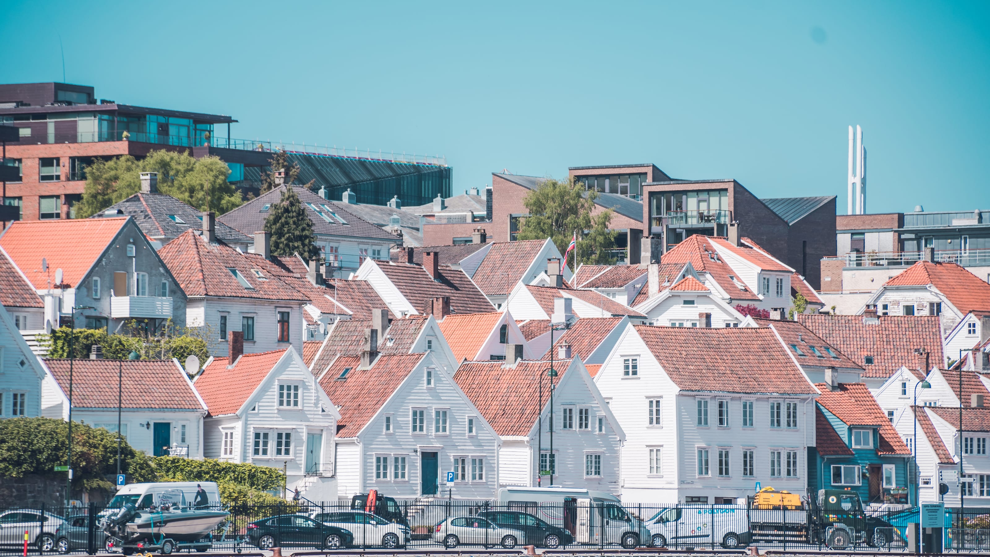 Red-roofed houses clustered above a Norwegian harbour in coastal Norway.