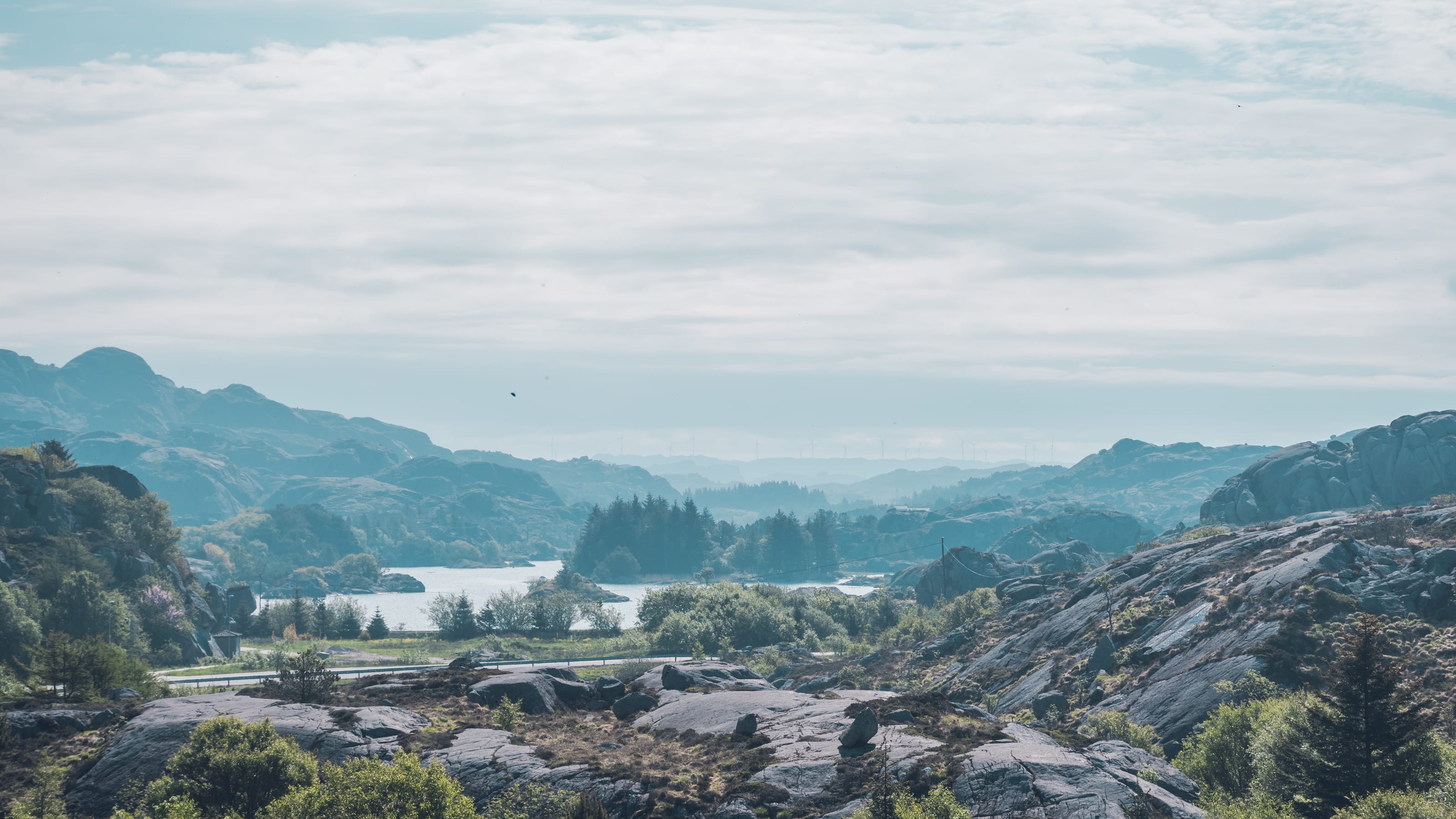 Blue mountain lake enclosed by weathered granite in coastal Norway.